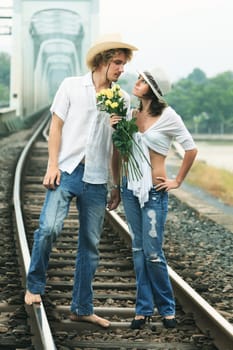 Young couple posing on a train tracks