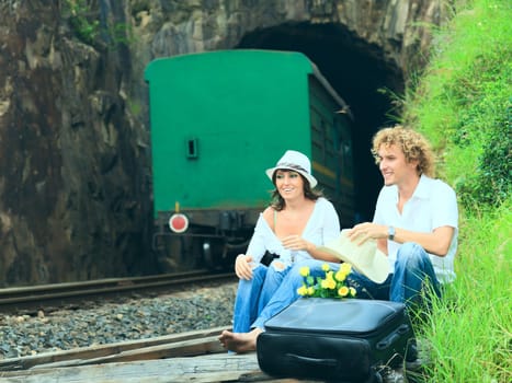 Young couple posing on a train tracks