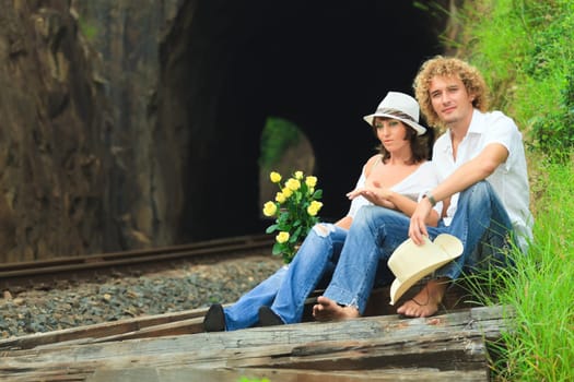 Young couple posing on a train tracks