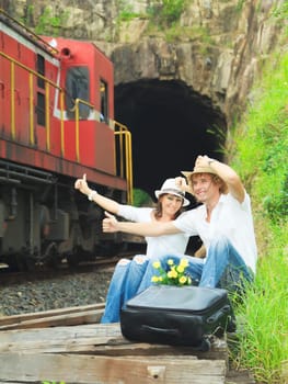 Young couple hitchhiking a train.