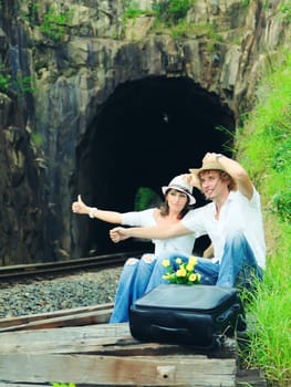 Young couple posing on a train tracks