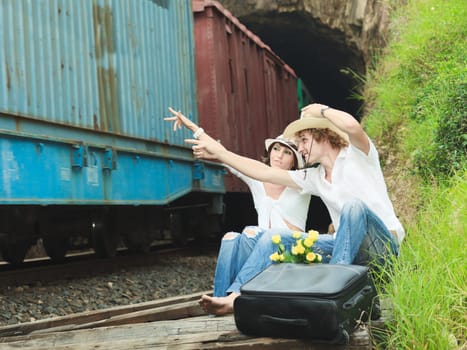Young couple posing on a train tracks