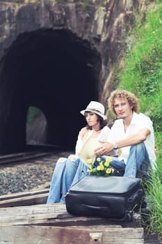 Young couple posing on a train tracks