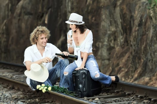 Young couple posing on a train tracks