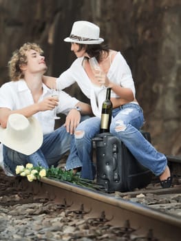 Young couple posing on a train tracks