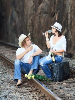 Young couple posing on a train tracks