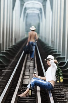 Young couple posing on a train tracks