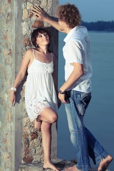Young couple near the river at twilight time