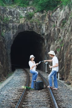 Young couple posing on a train tracks