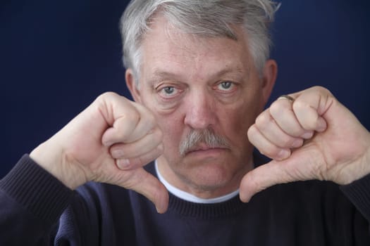 an older man with both thumbs down