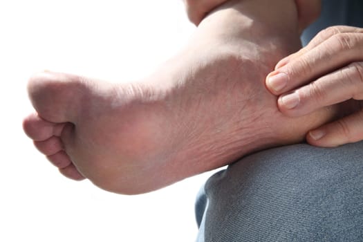a man tends to his aching foot