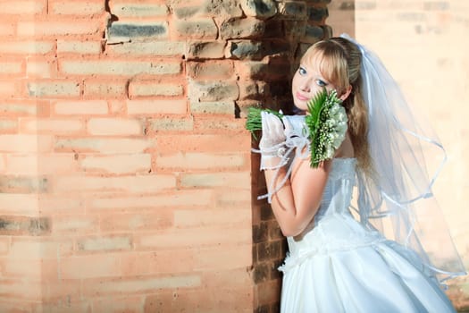 Beautiful young bride in wedding dress outdoor