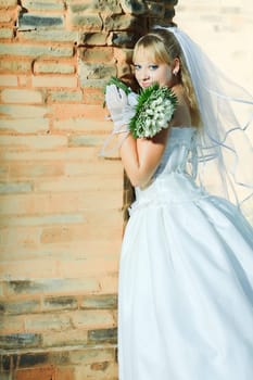 Beautiful young bride in wedding dress outdoor