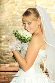 Beautiful young bride in wedding dress outdoor