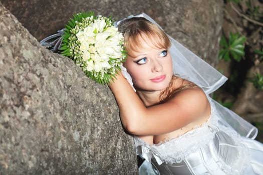 Beautiful young bride in wedding dress outdoor