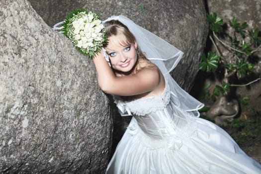Beautiful young bride in wedding dress outdoor