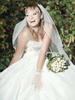Beautiful young bride in wedding dress outdoor
