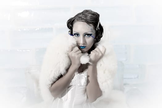 Woman as a snow queen in ice room