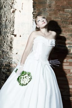 Beautiful young bride in wedding dress outdoor