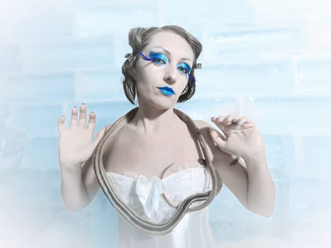 Woman as a snow queen in ice room