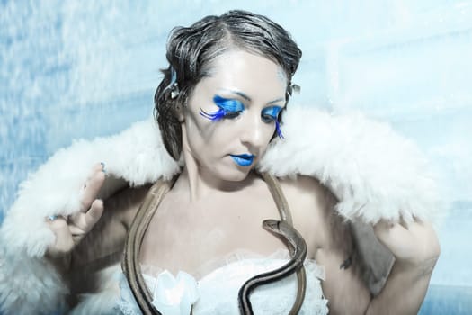 Woman as a snow queen in ice room