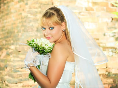 Beautiful young bride in wedding dress outdoor