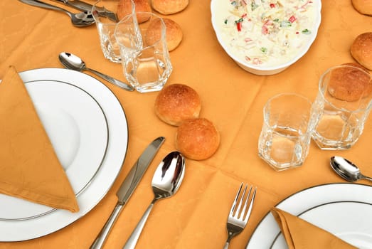 bread, plates  and salami on the table