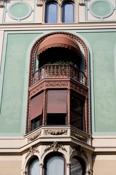 window with woodwork in the main street of Genoa