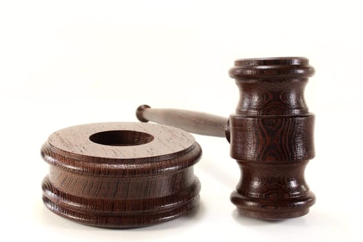 a brown judge's gavel against a white background