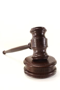 a brown judge's gavel against a white background