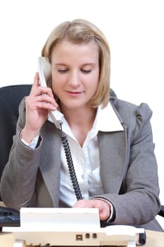 Young woman in office dials a phone number