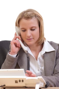 Young woman in office dials a phone number