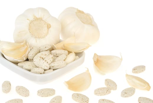 Garlic and herbal supplement pills isolated, alternative medicine concept