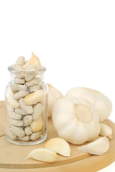 Garlic and herbal supplement pills isolated, alternative medicine concept