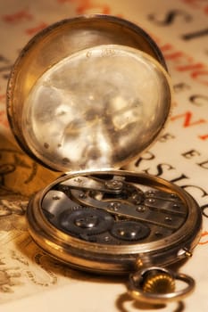 Antique clock onion on ancient book in Latin