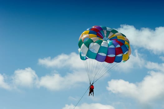 Paragliding pulled by a motorboat on the beach of &#039 equator