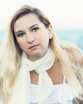 Young beautiful woman posing near the ocean