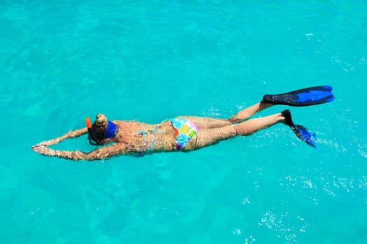 Young woman snorkeling in a tropical lagoon