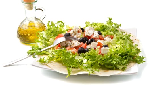 vegetarian piadina with fresh salad, tomatoes, olives and mozzarella cheese