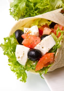vegetarian piadina with fresh salad, tomatoes, olives and mozzarella cheese