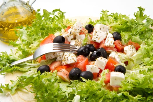 vegetarian piadina with fresh salad, tomatoes, olives and mozzarella cheese