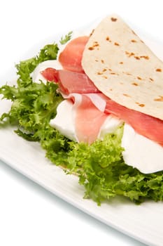 italian piadina with ham, fresh salad and mozzarella cheese