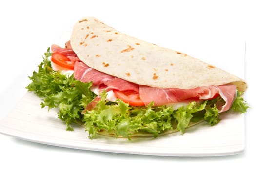 italian piadina with ham, fresh salad and mozzarella cheese