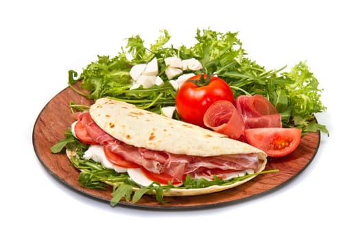 italian piadina with ham, fresh salad and mozzarella cheese
