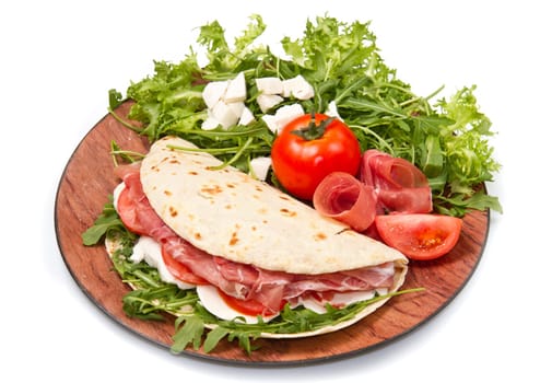 italian piadina with ham, fresh salad and mozzarella cheese