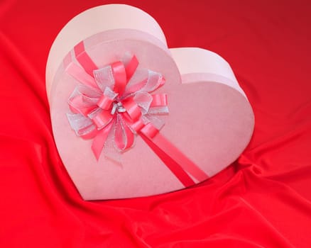 Gift box on the red silk background