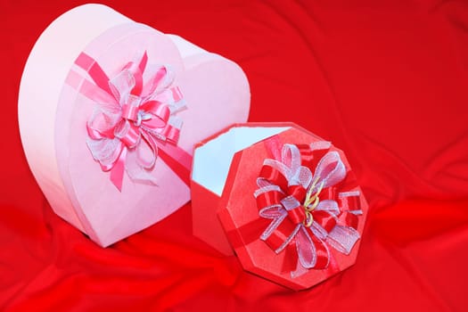 Gift box on the red silk background