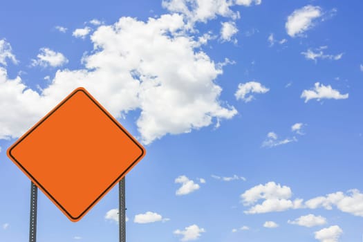 Yellow warning sign with text space in front of blue sky