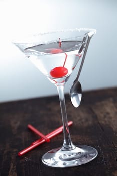 Dry Martini with a cherry on a aged background