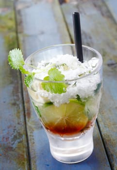 Lime Mojito Cocktail with fresh Cuban mint and crushed ice on grunged wooden background. For Drink concepts. For other Beverages view my portofolio.